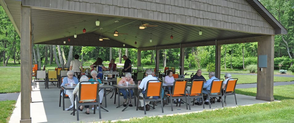 Residents enjoying a gathering in an outdoor pavilion