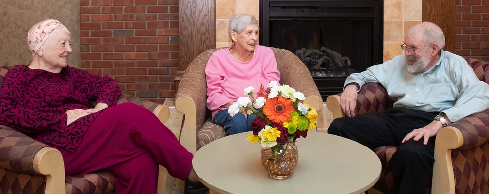 Residents enjoying conversation in a cozy common area