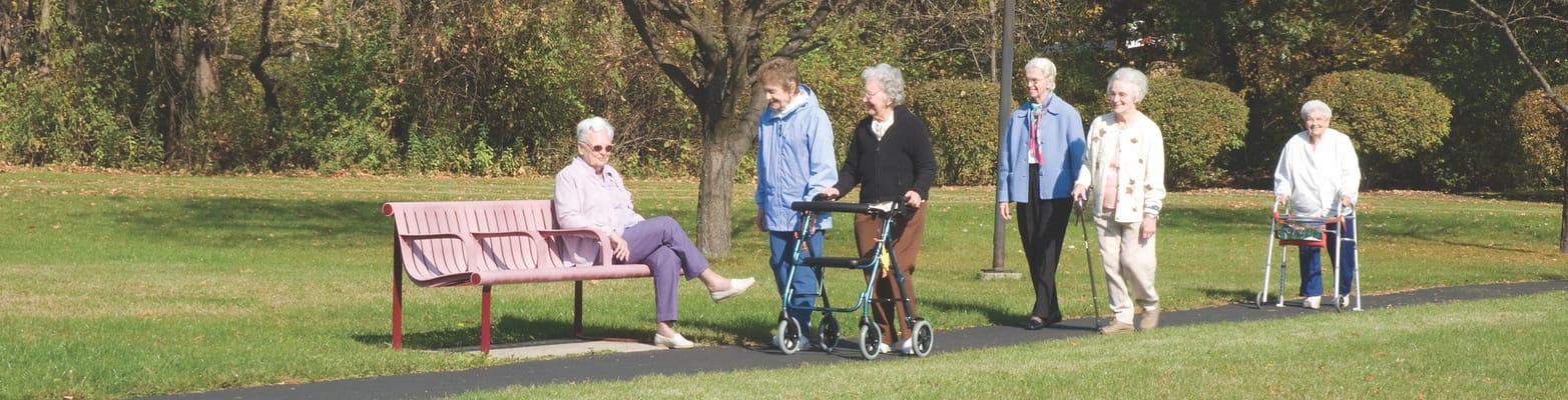 Residents walking on a path in the outdoor garden