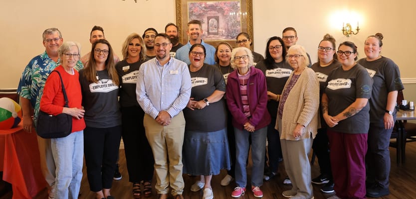 Staff and residents gathered for a group photo in a common area