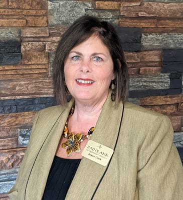 Staff member posing in a well-lit interior setting