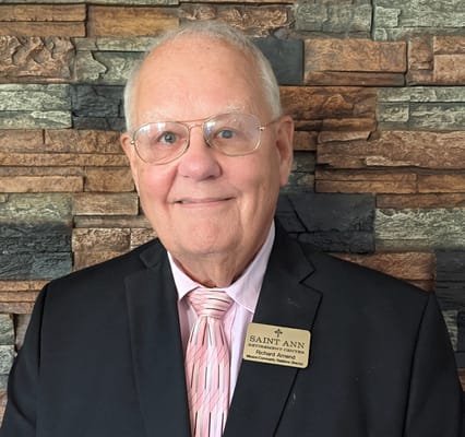 Senior staff member smiling in formal attire