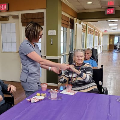 Staff assisting residents with activities in a common area