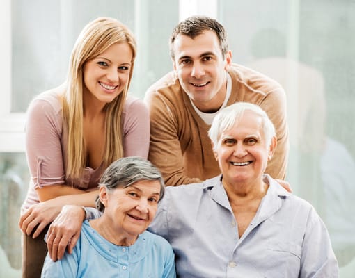 Smiling staff and residents posing for a photo together