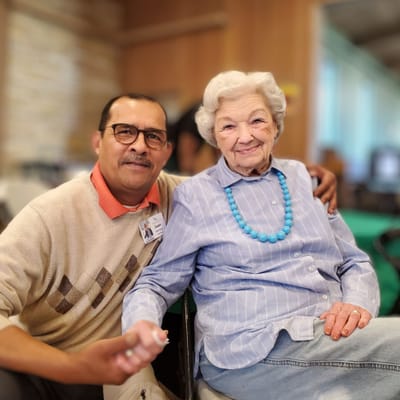 Staff member with resident in a bright common area