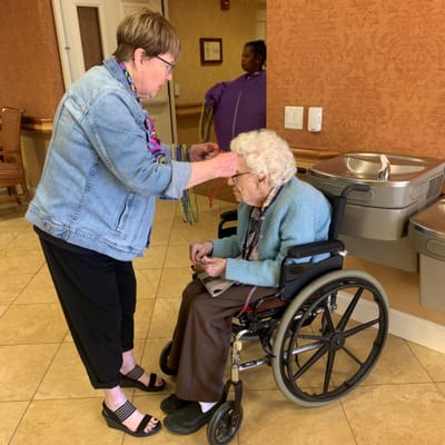 Staff member assisting a resident in a common area