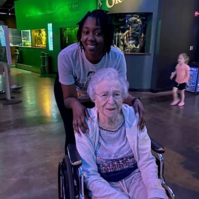 Care staff assisting a resident in a common area