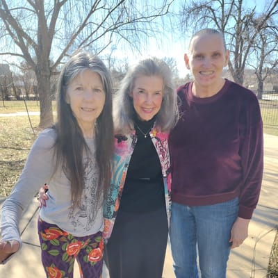 Three residents in a sunny outdoor area