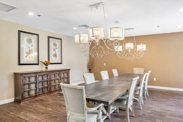 Elegant dining room with a long wooden table and chandelier