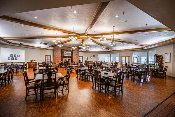 Bright dining area with wooden tables and chairs