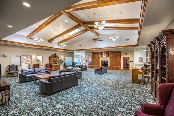 Spacious common area with comfortable seating and a fireplace