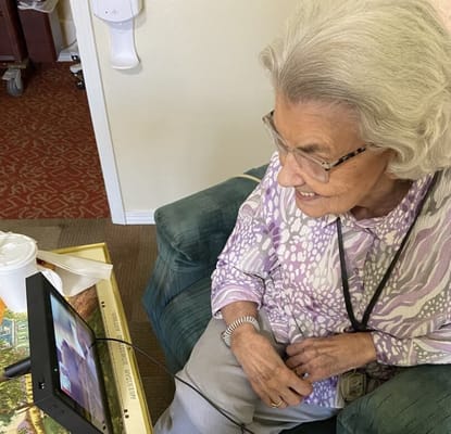 A resident enjoying video calls in a cozy interior