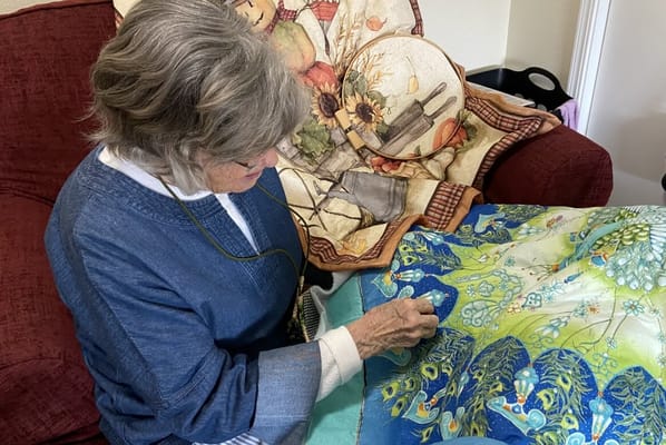 Resident crafting in a cozy living area