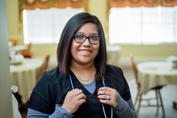 Staff member smiling in a dining area