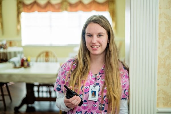 Staff member smiling in the dining area