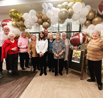 Residents celebrating at a festive party with balloons