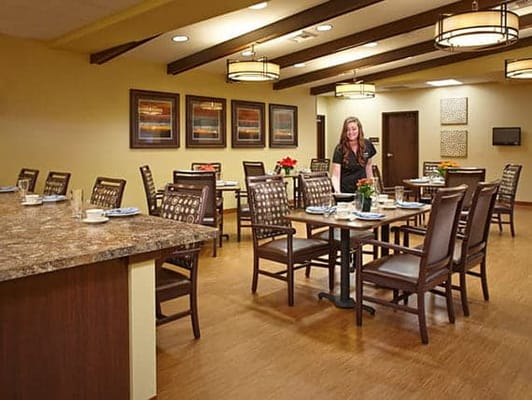 Dining room with seating and staff member