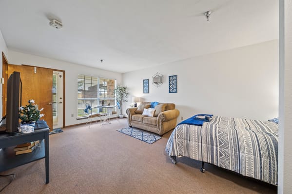 Cozy resident room with a bed and seating area