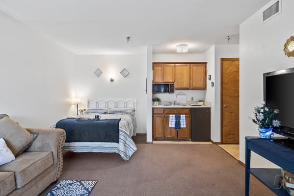 Cozy resident room with kitchen area and seating