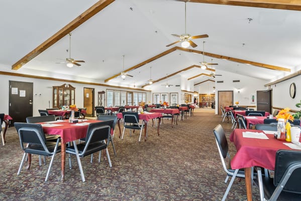 Bright dining room with red-covered tables