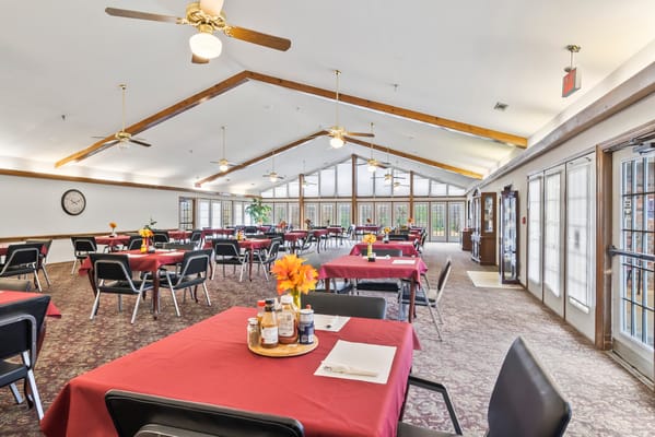 Dining area with table settings and flower centerpieces