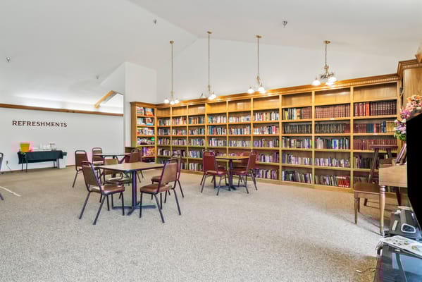 Common area with bookshelf and tables