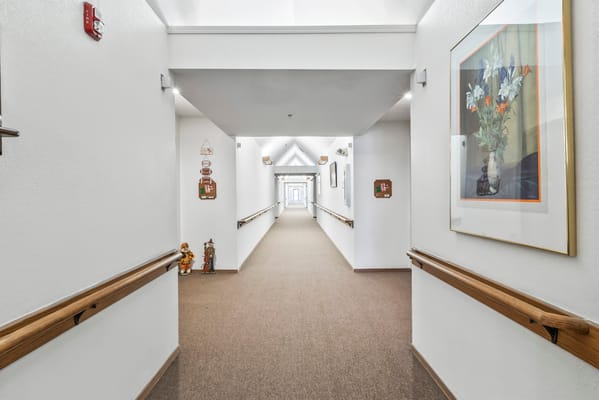A well-lit corridor with artwork and decorations