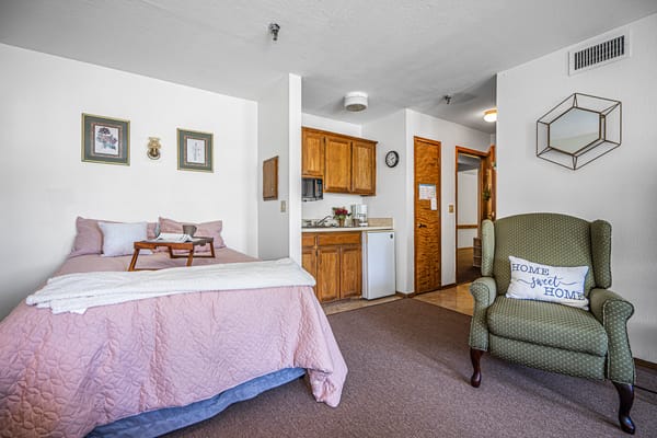 Cozy resident room with a bed and chair