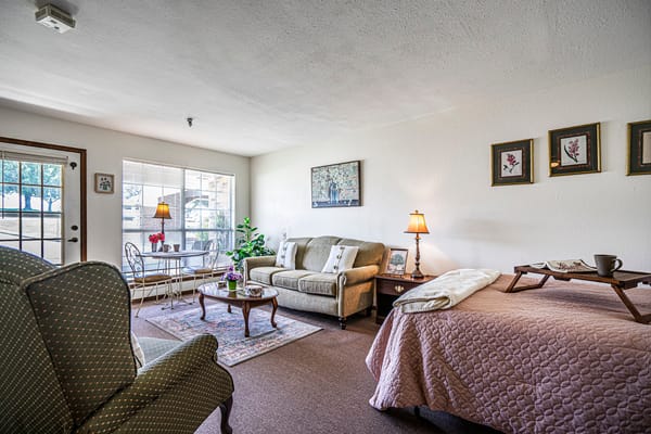 Cozy resident room with living area and bed