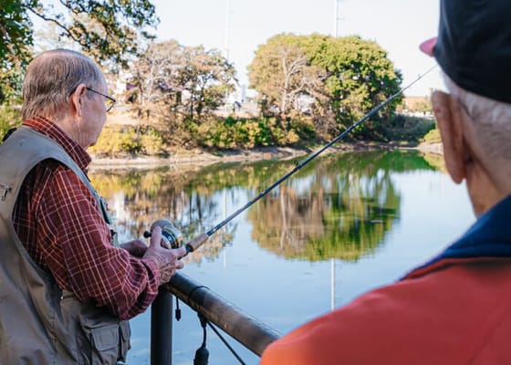 Residents fishing by a serene lake