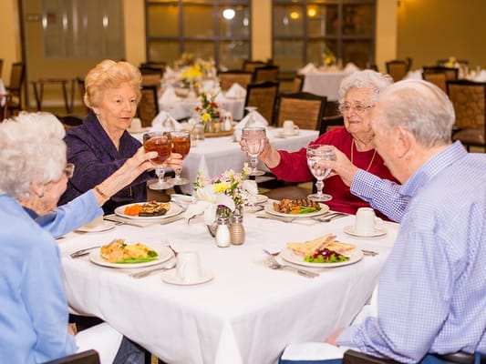 Residents enjoying a meal together in the dining room