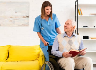 A staff member assisting a resident in a cozy common area