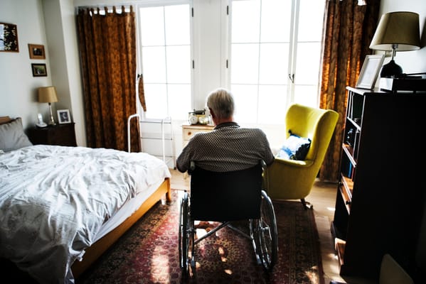 Resident in a wheelchair in a bright room