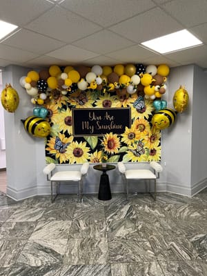 Brightly decorated common area with balloons and flowers