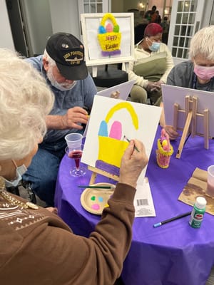 Residents participating in a painting activity
