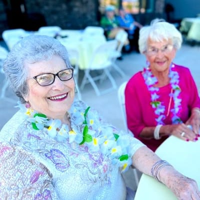 Two residents enjoying a festive outdoor event
