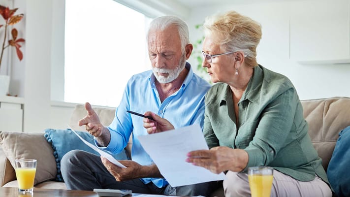 Two senior residents reviewing papers together
