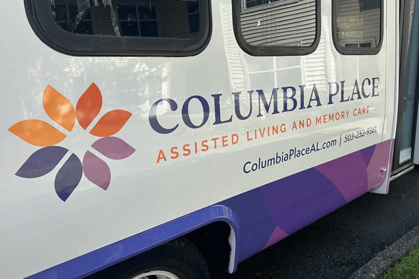 Vehicle with Columbia Place logo and branding