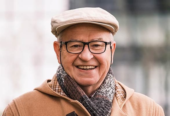Smiling elderly man in a cozy outdoor setting