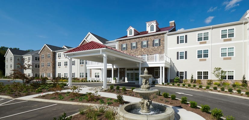 Exterior view of a senior living facility with landscaping