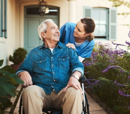 Caregiver assisting resident in a garden