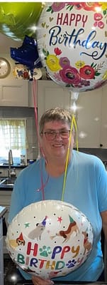 Resident celebrating a birthday with balloons