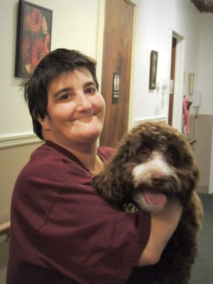 Staff member with a therapy dog in a hallway