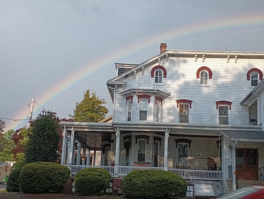 Exterior view of a senior care facility with a rainbow