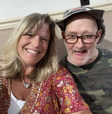 Residents smiling together in facility common area