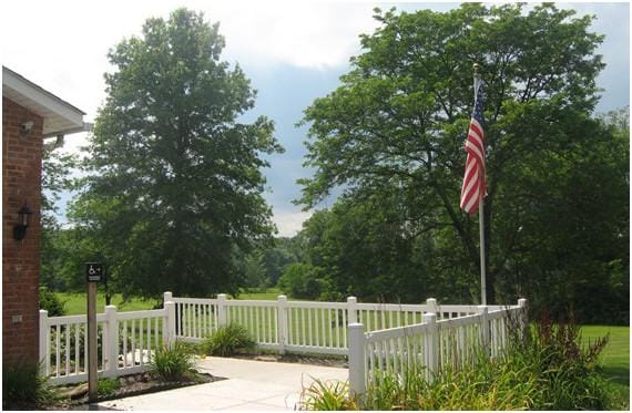 Exterior view of a facility with landscaping and flag
