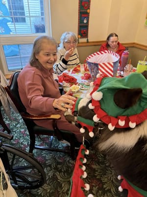 Residents enjoying a festive meal with a small horse
