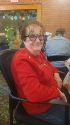 Resident wearing festive glasses at a holiday gathering