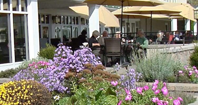 Residents enjoying a meal on an outdoor patio