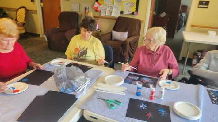 Residents engaged in a painting activity in common area